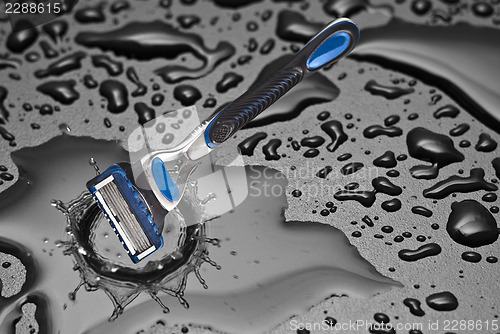 Image of shaving razor inside a drop of water