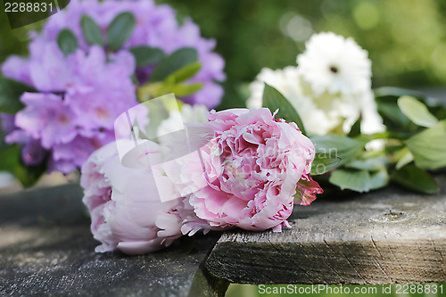 Image of peonies and garden flowers on wooden planks