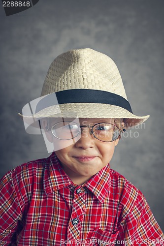 Image of boy in a cap and glasses
