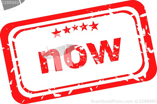 Image of now on red rubber stamp over a white background