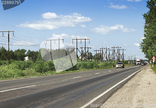 Image of Wooden supports  electrical line along highway