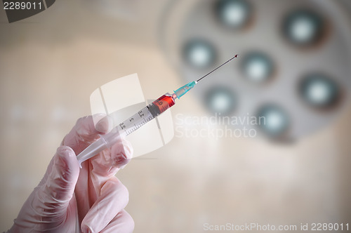 Image of Hand holding a syringe