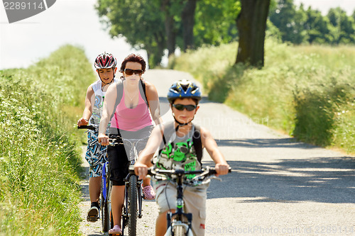 Image of Mother with two sons on bicycle trip