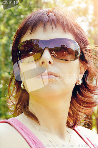 Image of outdoor portrait of pretty woman with reflection in sunglasses