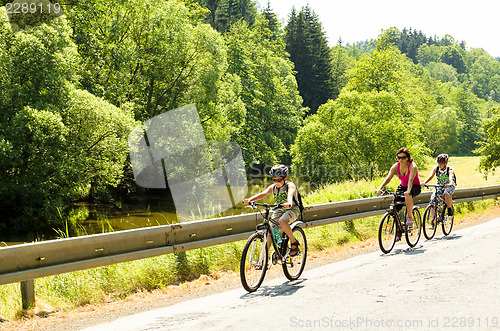 Image of Mother with two sons on bicycle trip