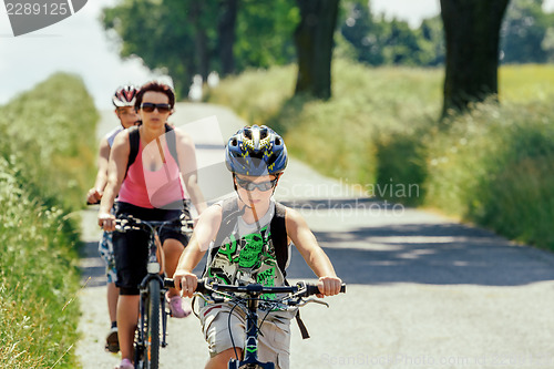 Image of Mother with two sons on bicycle trip