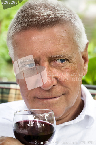 Image of Happy senior enjoying drink