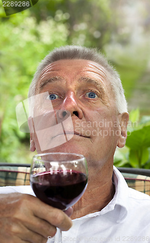 Image of Happy senior enjoying drink