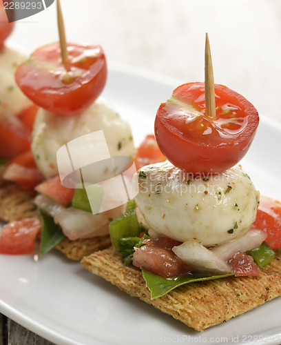 Image of Crackers With Mozzarella Cheese And Tomatoes