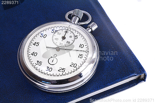 Image of Stopwatch and the notebook on a white background