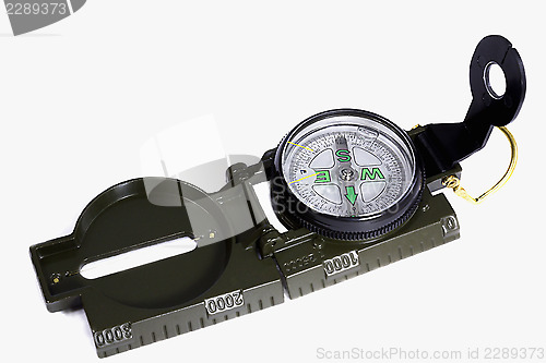 Image of A small compass in a metal frame on a white background.