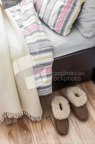 Image of Cozy slippers near bed