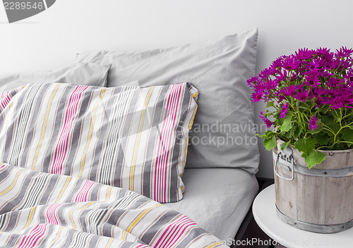 Image of Bedroom decorated with bright purple flowers