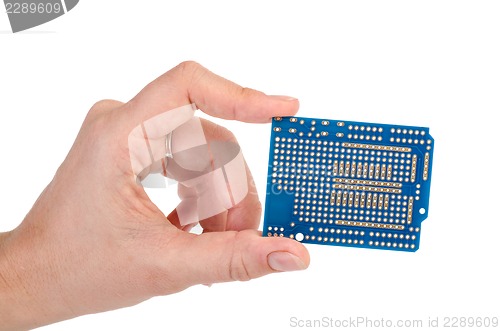Image of Blue prototyping PCB in a hand
