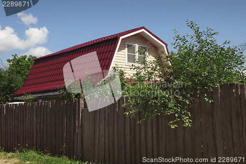 Image of Small country house behind a high fence