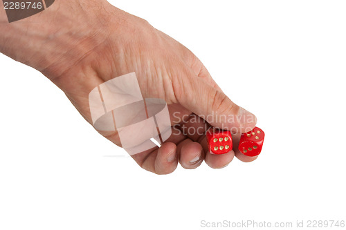 Image of Hand holding red dices