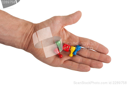 Image of Hand holding four pawns