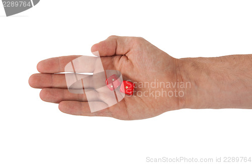 Image of Hand holding red dices