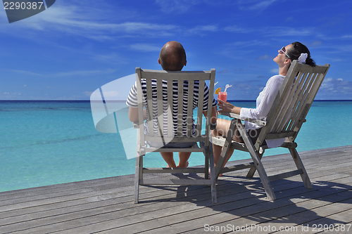 Image of happy young couple relax and take fresh drink