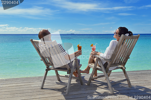 Image of happy young couple relax and take fresh drink