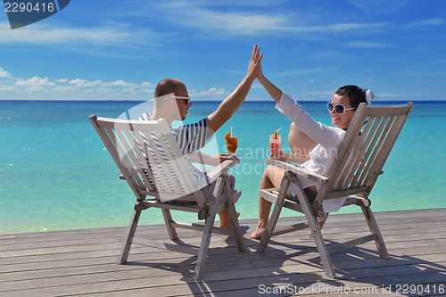 Image of happy young couple relax and take fresh drink