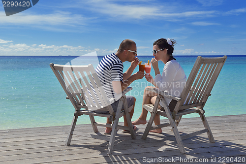 Image of happy young couple relax and take fresh drink