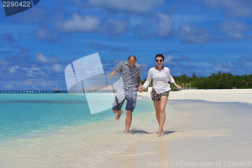 Image of happy young  couple at summer vacation have fun and relax at bea