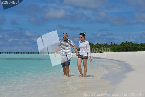 Image of happy young  couple at summer vacation have fun and relax at bea