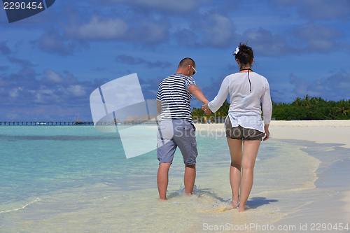 Image of happy young  couple at summer vacation have fun and relax at bea