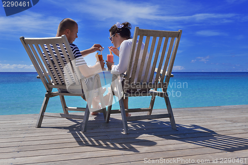 Image of happy young couple relax and take fresh drink