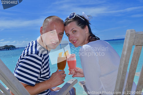 Image of happy young couple relax and take fresh drink