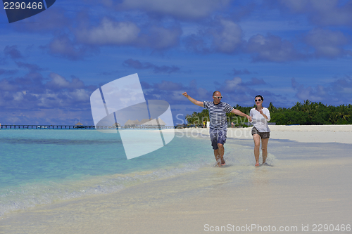 Image of happy young  couple at summer vacation have fun and relax at bea