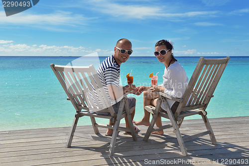 Image of happy young couple relax and take fresh drink