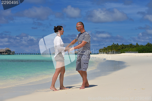 Image of happy young  couple at summer vacation have fun and relax at bea