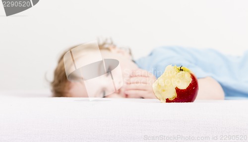 Image of apple with child in background