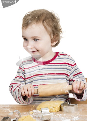 Image of happy young child with rolling pin in white background