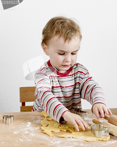 Image of child at desk making cookies