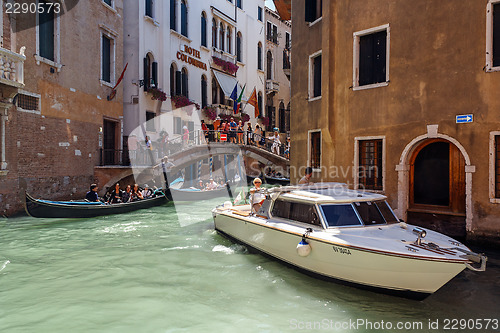 Image of ITALY, VENICE - JULY 2012: Heavy traffic of gondolas with tourists cruising a small canal on July 16, 2012 in Venice. Gondola is a major mode of touristic transport in Venice, Italy. 