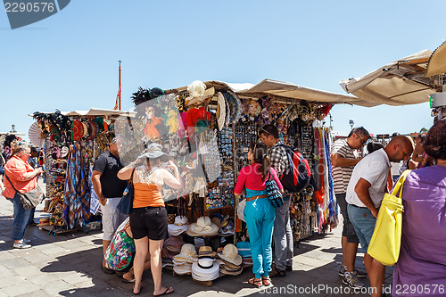 Image of ITALY, VENICE - JULY 2012: - Vendor selling tourist souvenirs on July 16, 2012 in Venice. Most vendors in Venice aren't of Italian origin. 