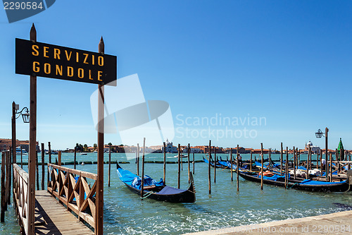 Image of ITALY, VENICE - JULY 2012: Gondolas moor on July 16, 2012 in Venice. Gondolas are traditional flat-bottomed rowing boats that today mainly carry tourists.