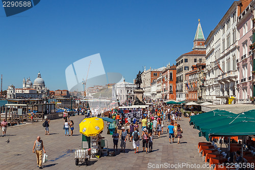 Image of ITALY, VENICE - JULY 2012: Venice waterfront with crowd of tourist near St Marco Square on July 16, 2012 in Venice. St Marco Square is the largest and most f