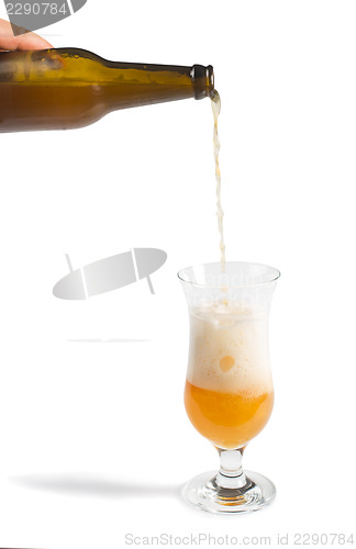Image of Hand holding bottle of beer and beer mug