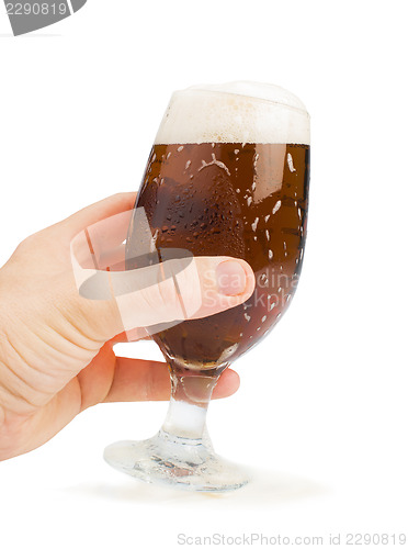 Image of Hand holding bottle of beer and beer mug