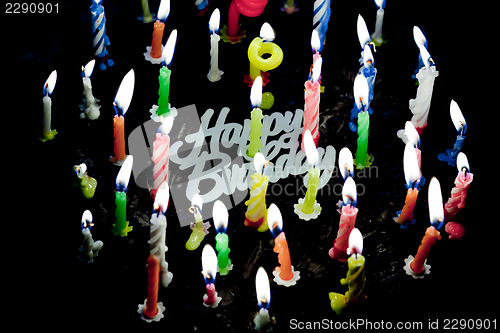 Image of Candels on chocolate cake in the dark