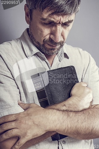 Image of man holding a bible