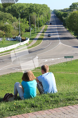 Image of Pair young enamoured people near the road