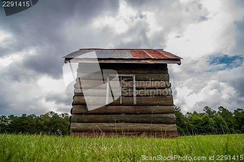 Image of old wood log cabin in forest