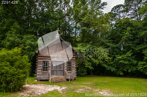 Image of old wood log cabin church in forest