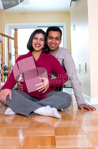 Image of Happy expectant couple at home