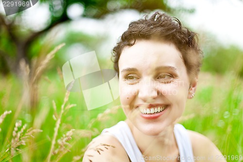 Image of cute girl on green field 